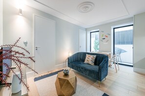 Relax in this stylish living room with a sofa, coffee table, and balcony view.