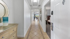 A hallway with a light fixture, a mirror, and a door with a keypad lock. - Centre Court Cay: Water Park, Golf View, Pool, Near Disney (Kissimmee)