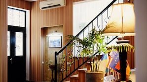 A staircase with a potted plant, a lamp, and a framed picture on the wall. - Darchi Hotel (Tbilisi)