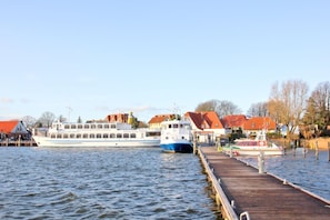 A river with a dock and a large boat named 'Mappen Von Brees'.
