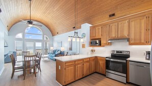 A kitchen with wooden cabinets, a stainless steel oven, and a dishwasher.