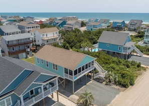 A coastal residential area with houses featuring balconies and waterfront views.