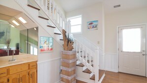 A staircase with white railings and a wooden base, leading to a second floor. - Hobbs Realty - “Casa Del Mar” | 4BR Marsh-View Home w/ Private Gazebo (Holden Beach)