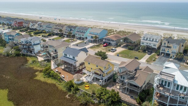 A coastal residential area with houses featuring balconies and waterfront views. - Hobbs Realty - “Casa Del Mar” | 4BR Marsh-View Home w/ Private Gazebo (Holden Beach)