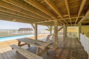 Relax by the pool in an outdoor space with a deck and lounge chairs.