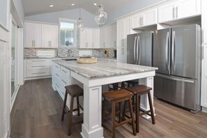 Fridge, microwave, oven, stovetop - Hobbs Realty - "Coast is Clear," an oceanfront home with a heatable pool, hot tub, and elevator. (Holden Beach)