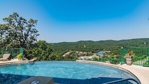A swimming pool with a clear view of a mountainous landscape in the background. - Lake & Mountain View Condo - The Cliffs on Indian Point - Silver Dollar City (Branson)