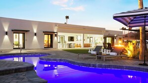 A modern outdoor pool area with a hot tub, lounge chairs, and a well-maintained lawn. - SWSS 7BR Estate | Golf Sim | Sauna | Pool | Hot Tub | Putting Green | Volleyball | Games (Scottsdale)