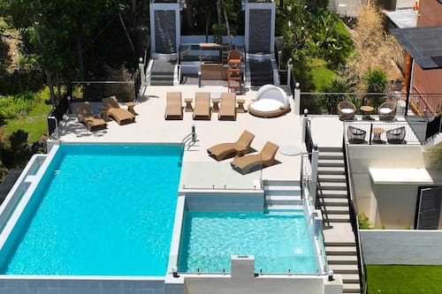 Outdoor pool, pool umbrellas, lifeguards on site