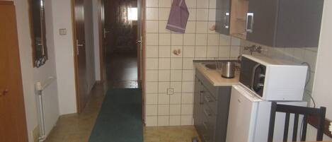 Fridge, microwave, coffee/tea maker, cookware/dishes/utensils