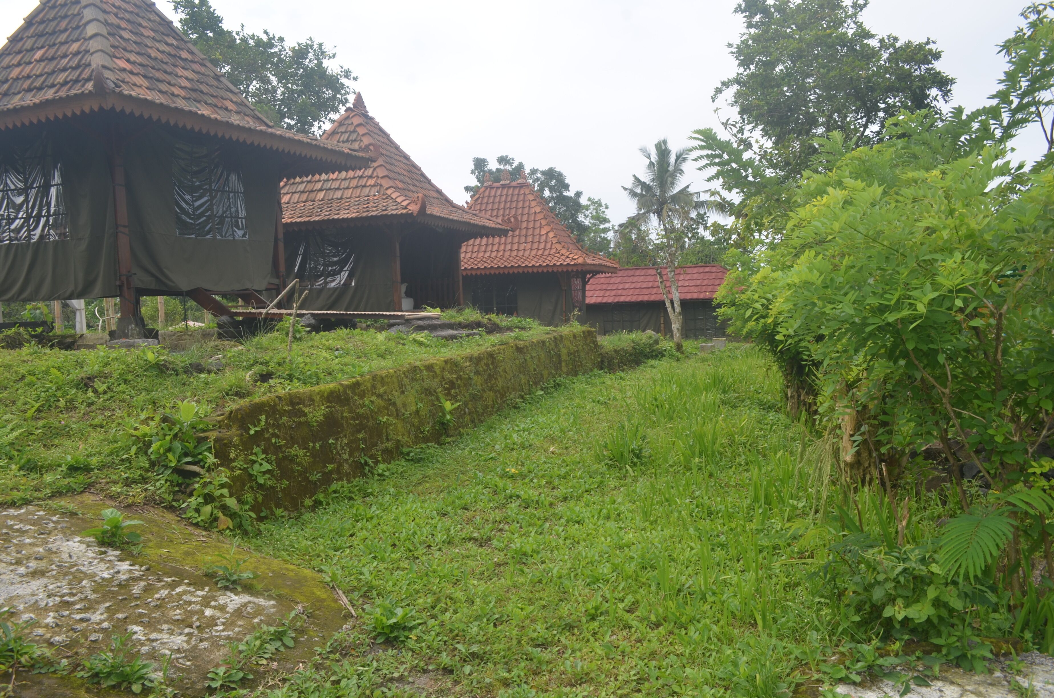 A traditional building with a tiled roof and a thatched roof structure.