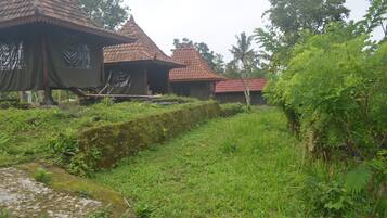 A traditional building with a tiled roof and a thatched roof structure.