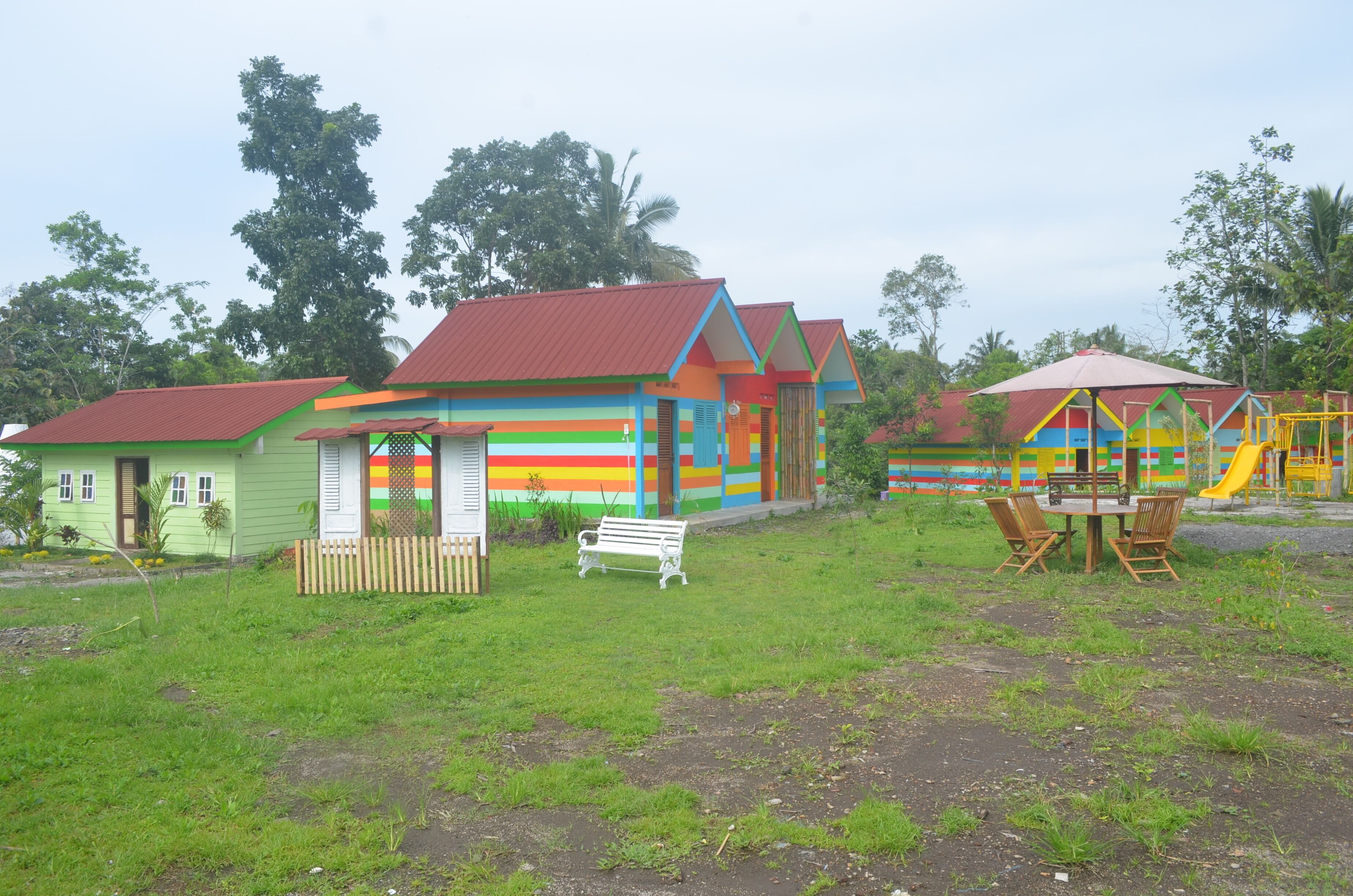 A colorful playground with a slide and swings.