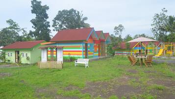 A colorful playground with a slide and swings.