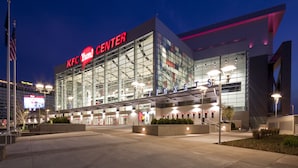 A modern KFC building with large glass windows, a prominent sign, and a well-lit entrance area. - Stellar Suites (Louisville)