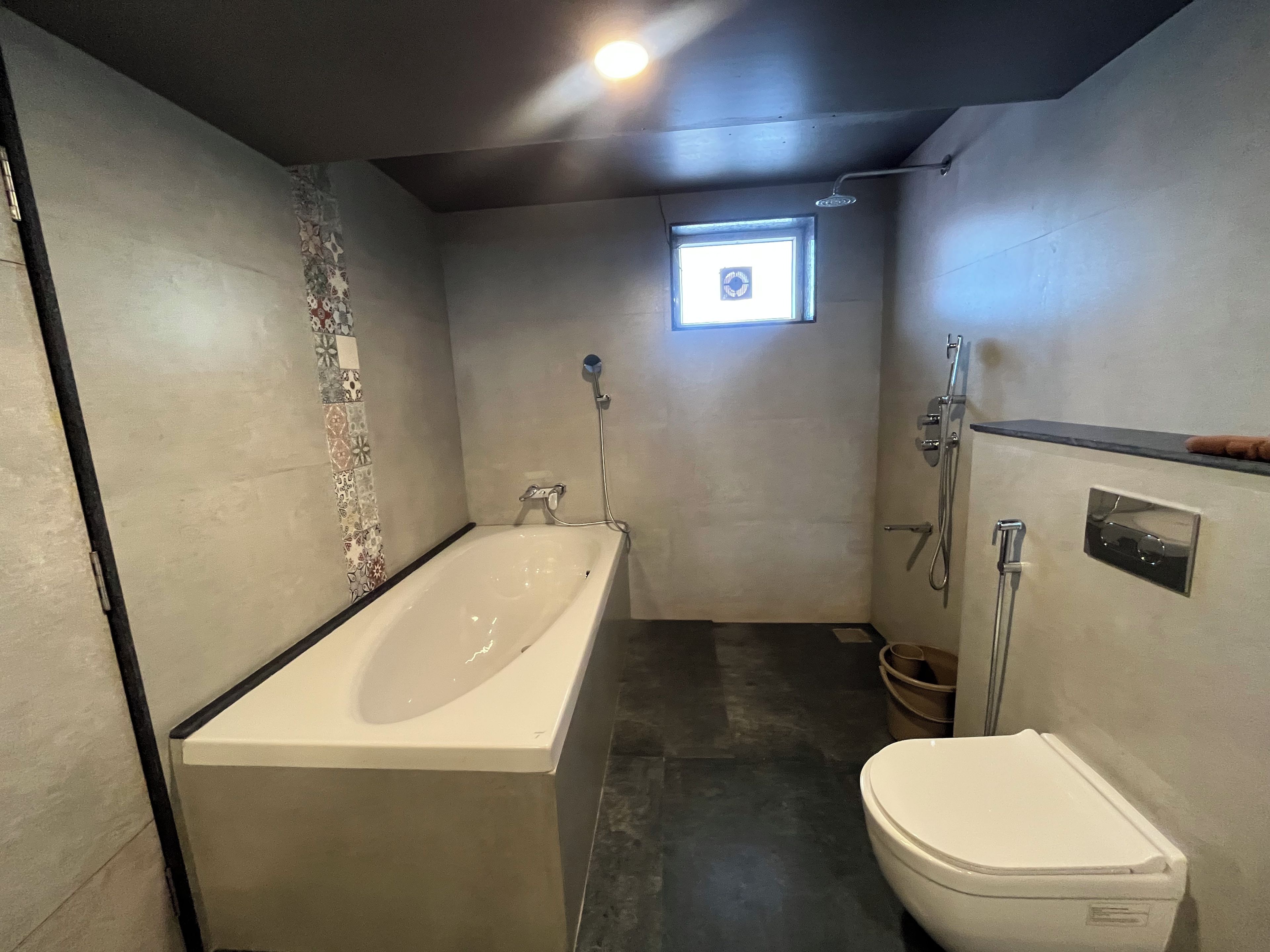A bathroom with a bathtub, toilet, and shower.