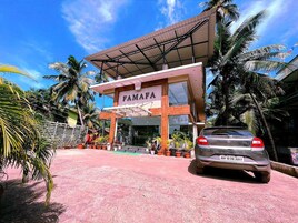 A building with a sign reading 'FAMAPA' and a parked car in front.