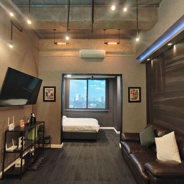 Design Condo | Living area | 64-inch Smart TV with digital channels, Netflix, streaming services - Voss Condominium (Quezon City)