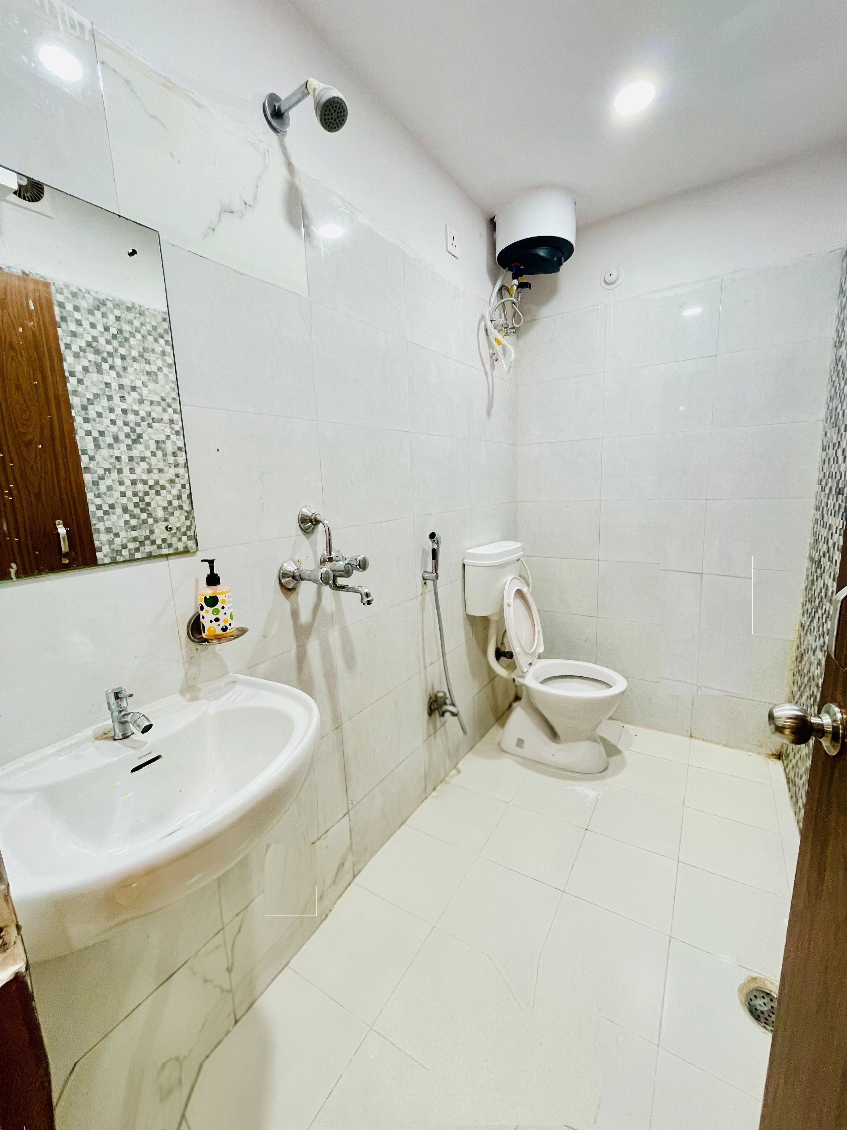 A bathroom with a sink, toilet, and shower.