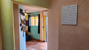 A hallway with a wall-mounted sign that reads "Love never fails."