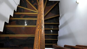 A wooden spiral staircase with a polished finish and gold accents. - Ducato di Aria  (Nafplio)