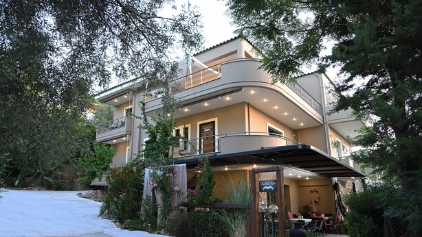 A two-story building with a covered outdoor seating area and a sign reading "Duchess of Aria." - Ducato di Aria  (Nafplio)