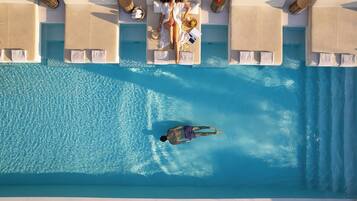 A swimming pool with lounge chairs and towels.