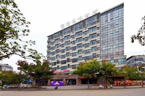 A multi-story hotel with a modern facade, large windows, and a flat roof.