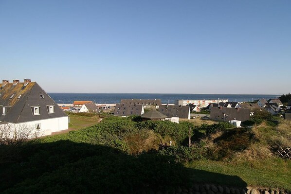 A coastal village with houses and a view of the sea.