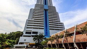 A tall, modern building with a prominent blue vertical stripe. - Patong Tower Beach Apartment By Seesea (Patong)
