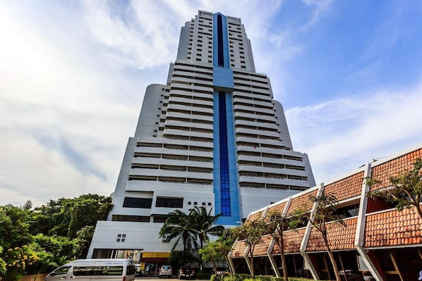 A tall, modern building with a prominent blue vertical stripe.