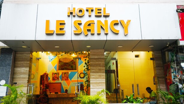 The exterior of Hotel Le Sancy with a prominent sign and a colorful entrance. - Hotel Le Sancy (New Delhi)