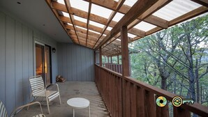 A covered porch with wooden beams and a view of trees. - Mountainside Retreat Condo (#1-302) | Top-level w/ loft | Quiet & secluded (Basye)