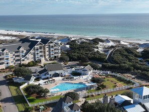 A resort with a swimming pool, beach access, and a large building with multiple balconies. - New Rental Beach Front Condo In Watersound Beach Fl With Stunning Views! 3 Bedroom Condo by RedAwning (Santa Rosa Beach)