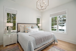 A bedroom with a bed, nightstands, lamps, and large windows. - Upscale Beach Estate With Private Pool + Carriage House And Less Than 300 Yards From The Beach 6 Bedroom Home by RedAwning (Santa Rosa Beach)