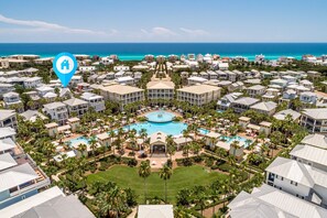 A resort with multiple buildings, a central pool, and a view of the ocean. - Luxurious "carefree Cottage" In Seacrest Beach Walk To The Beach, Steps To The Pool & Tram 3 Br 3 Bedroom Home by RedAwning (Panama City Beach)