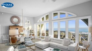 A spacious living room with a large sectional sofa, a glass coffee table, and a view of the beach through large windows. - Amazing Gulf Views 425a Watersound Crossings 3br Steps To Beach And Pool! 3 Bedroom Condo by RedAwning (Santa Rosa Beach)