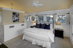 A bedroom with a large bed, two bedside tables with lamps, a ceiling fan, and a window with curtains. - Steps To Beach Club, Multi-level Watercolor Condo, Slps 4, Perfect Location! 1 Bedroom Condo by RedAwning (Santa Rosa Beach)