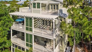 A multi-story house with a balcony on the second floor and a covered patio on the first. - Steps To Beach Club, Multi-level Watercolor Condo, Slps 4, Perfect Location! 1 Bedroom Condo by RedAwning (Santa Rosa Beach)