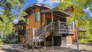 A modern wooden cabin with a balcony and a staircase leading to a deck. - Serene Forest-Front Retreat: 4BR Rocky Ridge Gem (Tahoe City)