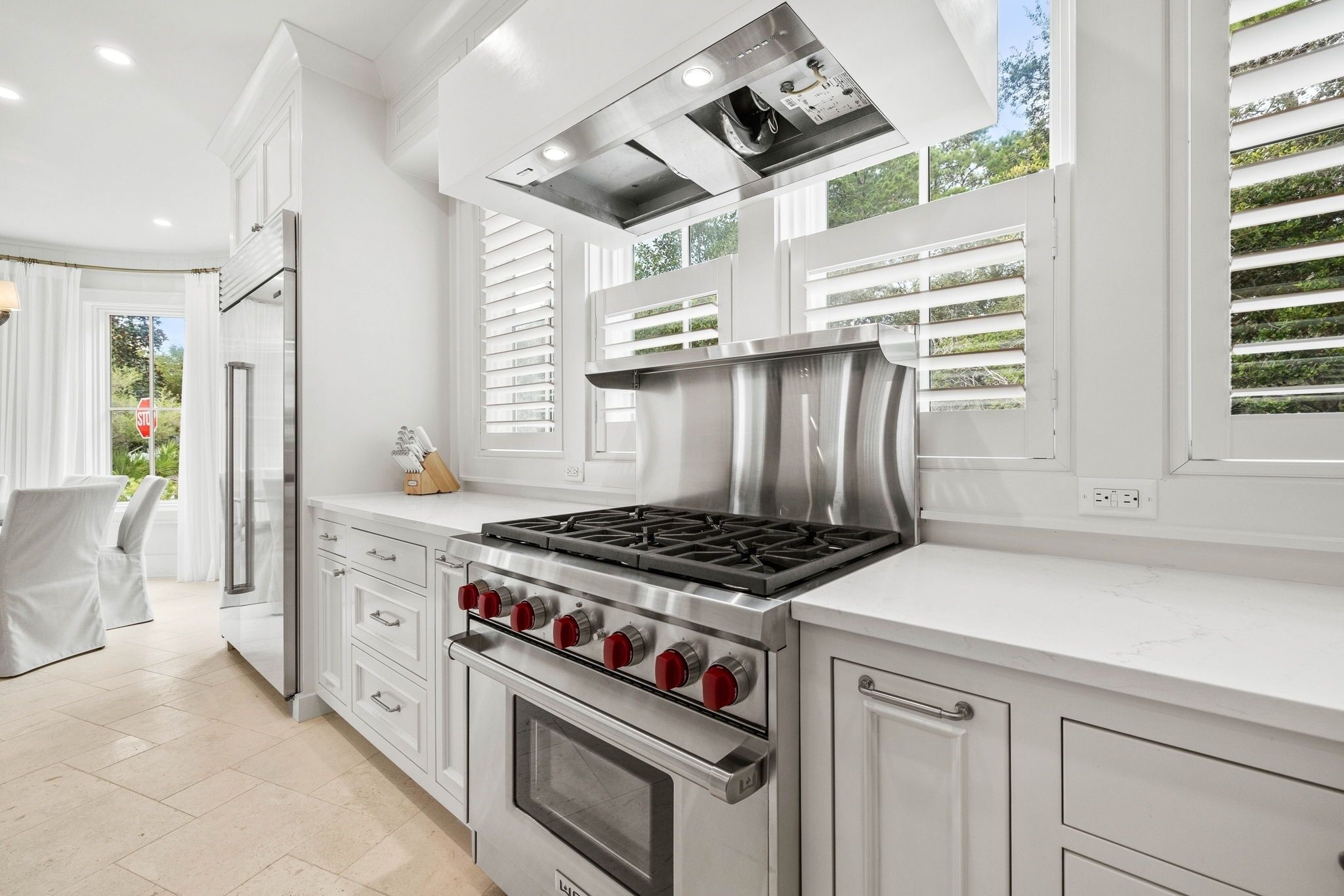 A modern kitchen with a stainless steel range, oven, and built-in stove.