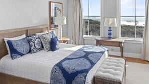 A bedroom with a large bed, two bedside tables, a view of the beach, and a window with curtains. - Beautiful Gulf Views Spacious, Updated 316b Watersound Crossings Steps To Beach And Pool 3 Bedroom Condo by RedAwning (Santa Rosa Beach)