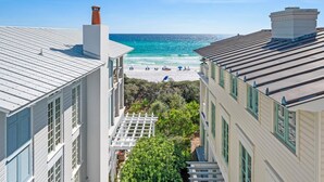 A coastal building with a view of the beach and ocean. - Gulf Views Steps To Seaside Town Center Bella Vita - Newly Remodeled! 4 Bedroom Home by RedAwning (Santa Rosa Beach)