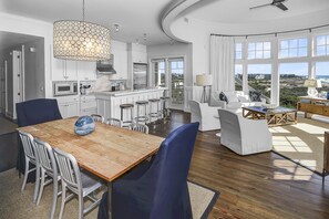 A modern kitchen with white cabinets, stainless steel appliances, and a wooden island. - Gulf Front Penthouse Condo Complimentary Golf Cart 407 Compass Point 1, Watersound - 3 Br, Slps 8 3 Bedroom Condo by RedAwning (Santa Rosa Beach)