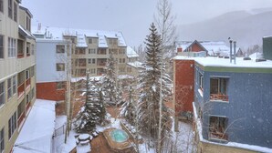 A residential area with multi-story buildings, a snow-covered landscape, and a visible swimming pool. - Silver Mill 8253-1br-walk To Slopes! Kids Ski Free! 1 Bedroom Condo by RedAwning (Keystone)