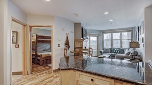 A modern kitchen with a granite countertop, wooden cabinets, and a built-in oven.