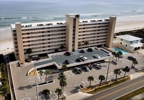 Un hôtel à plusieurs étages doté d’un parking, d’une piscine et offrant une vue sur la plage.