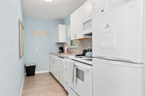Enjoy cooking in this well-equipped kitchen with a stove, refrigerator, and ample countertop space.