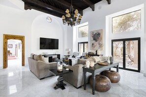 TV, fireplace, books - Casablanca Gardens by LuxeKey | Moroccan Estate w/ Pool & Pickleball (Paradise Valley)