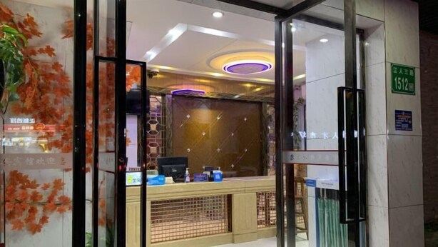 A hotel reception area with a glass door, a reception desk, and a sign indicating room number 1512. - Fu an Hotel (Guangzhou)
